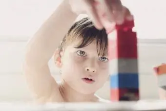 Väike poiss mängib vannis klotsidega