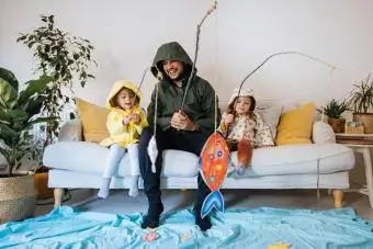 Deti a otec hrajúci sa doma na rybačke
