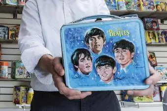 Брэндон Гамильтон Beatles тобунун металлдан жасалган түшкү кутуларын кармап турат
