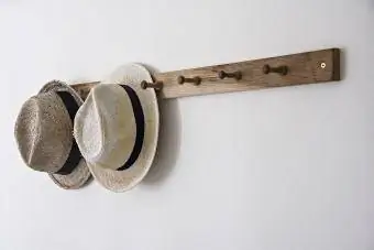 Шляпы висят на крючке на стене