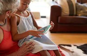 fille jouant à un jeu sur une tablette numérique