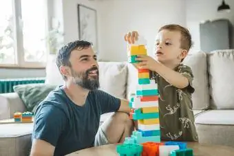 Հայրն ու որդին տանը խաղում են գունավոր բլոկների հետ