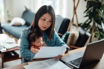 Ibu muda dengan bayi perempuan bekerja dari rumah