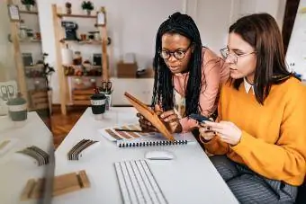 Amis discutant sur une tablette numérique au bureau