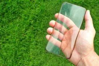 Hand Holding Clear Phone Case Against Grass