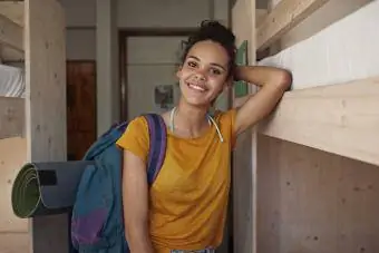 Dospívající dívka s batohem v hostelu