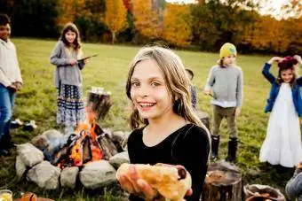 crianças comemorando o outono com um churrasco na fogueira