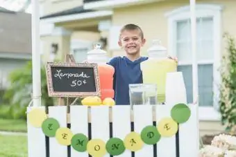 Dječak prodaje limunadu ispred dvorišta