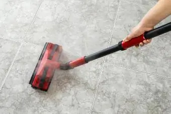 Wanita membersihkan pembersihan uap lantai