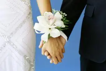 Casal adolescente de mãos dadas em um baile de formatura