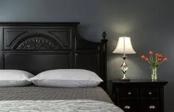 מיטה צבועה בשחור בפנים חדר שינה מודרני