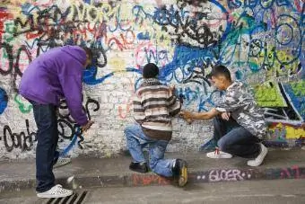 Tieners spuiten graffiti op de muur