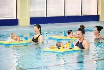 Yüzme dersinde bebekleriyle eğlenen annelerin fotoğrafı