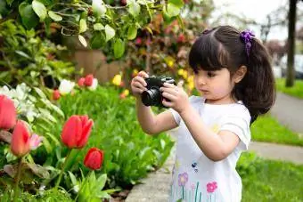 Gadis muda mengambil gambar tulip